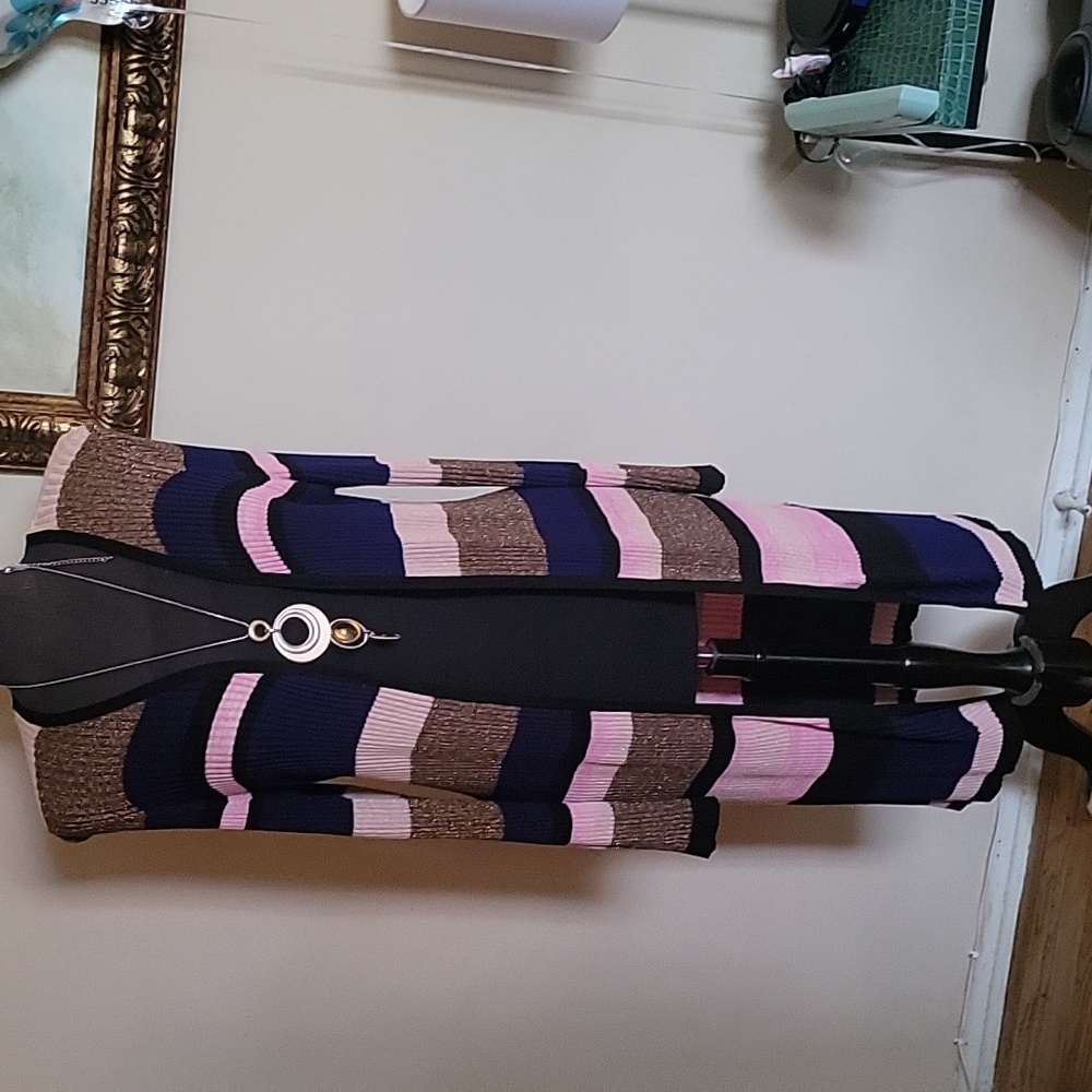 A long sweater, made up of gold,pink, and blue. It's  a 1x by I.N.C